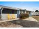 Inviting front yard with two yellow chairs and a paved pathway at 1956 Massachusetts Ave, Englewood, FL 34224