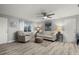 Living room with light walls and wooden floors, featuring a comfy sofa and arm chair at 1956 Massachusetts Ave, Englewood, FL 34224