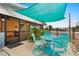 Outdoor patio with teal table and chairs at 1956 Massachusetts Ave, Englewood, FL 34224