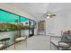 Screened porch with seating and cabinet at 1956 Massachusetts Ave, Englewood, FL 34224