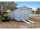 Gray storage shed with a ramp next to a golf cart at 1956 Massachusetts Ave, Englewood, FL 34224