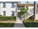 Condo building exterior showcasing stairs and landscaping at 200 Mirabella Cir # 201, Venice, FL 34292