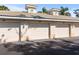 Three-car garage exterior with light beige siding, and attached to the main building at 200 Mirabella Cir # 201, Venice, FL 34292