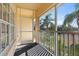 Screened balcony offering peaceful views of tropical foliage at 200 Mirabella Cir # 201, Venice, FL 34292