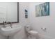 Small bathroom with pedestal sink, toilet, and framed mirror at 2114 5Th E St, Palmetto, FL 34221