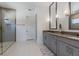 Elegant bathroom with double vanity, large mirror, and walk-in shower at 2114 5Th E St, Palmetto, FL 34221