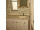 Small bathroom with pedestal sink and floral wallpaper at 232 Trailorama Dr, North Port, FL 34287