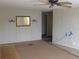 Living room with wood paneling and ceiling fan at 232 Trailorama Dr, North Port, FL 34287