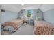 Twin bedroom with floral bedding and a shared bath at 235 64Th St, Holmes Beach, FL 34217