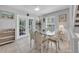 Bright dining area with glass table and wicker chairs near balcony at 235 64Th St, Holmes Beach, FL 34217