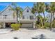 Two-story beach home with private balconies and attached garage at 235 64Th St, Holmes Beach, FL 34217