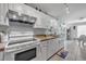 Bright kitchen featuring white cabinets and stainless steel appliances at 235 64Th St, Holmes Beach, FL 34217