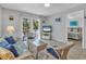 Living room with sofa, chairs, and view into the bedroom at 235 64Th St, Holmes Beach, FL 34217