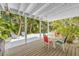 Covered patio with table and chairs, overlooking the backyard at 235 64Th St, Holmes Beach, FL 34217