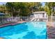 Inviting community pool with lounge chairs and umbrellas at 235 64Th St, Holmes Beach, FL 34217