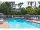 Inviting community pool with lounge chairs and umbrellas at 235 64Th St, Holmes Beach, FL 34217