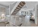 White staircase leading from the living area to the upper floor at 235 64Th St, Holmes Beach, FL 34217