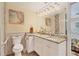 Elegant bathroom with granite vanity, updated lighting, and a large mirror at 2424 Post Rd, Sarasota, FL 34231