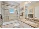 Clean bathroom with tub shower combo, granite vanity and updated lighting at 2424 Post Rd, Sarasota, FL 34231