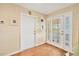 Bright and airy entryway with herringbone floors and modern doors at 2424 Post Rd, Sarasota, FL 34231