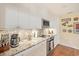 Bright kitchen with granite countertops and white shaker cabinets at 2424 Post Rd, Sarasota, FL 34231