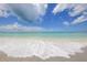 Soft waves lapping on sandy beach under blue sky at 2424 Post Rd, Sarasota, FL 34231