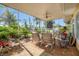 Relaxing screened porch with patio furniture and ceiling fan at 2424 Post Rd, Sarasota, FL 34231