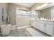 Bathroom with double vanity and walk-in shower at 26858 Weiskopf Dr, Englewood, FL 34223