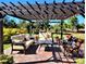 Relaxing patio with pergola, seating and landscaping at 26858 Weiskopf Dr, Englewood, FL 34223