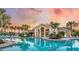 Community pool with clubhouse at sunset at 26858 Weiskopf Dr, Englewood, FL 34223