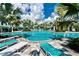 Community pool with lounge chairs and palm trees at 26858 Weiskopf Dr, Englewood, FL 34223