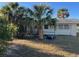 Side view of a single story home with palm trees and lawn at 2710 Hibiscus St, Sarasota, FL 34239