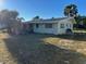 Back view of a single story home with spacious lawn at 2710 Hibiscus St, Sarasota, FL 34239