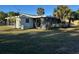 Side view of a single story home with carport and lawn at 2710 Hibiscus St, Sarasota, FL 34239