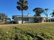 Side view of a light green house with palm trees at 2710 Hibiscus St, Sarasota, FL 34239