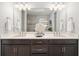 Bathroom with a double vanity and a large mirror reflecting the entire space at 275 Toscavilla Blvd, Nokomis, FL 34275