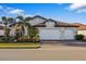 Two-story house with white double garage doors and landscaping at 275 Toscavilla Blvd, Nokomis, FL 34275