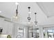 Three stylish glass dome pendant lights above kitchen island at 275 Toscavilla Blvd, Nokomis, FL 34275