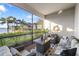 Relaxing screened porch with comfy seating and a view of the lake at 275 Toscavilla Blvd, Nokomis, FL 34275