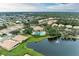 Aerial view of community, highlighting homes, pond, and pool area at 2831 Whispering Pine Ln, North Port, FL 34287