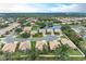 Community overview; showcasing homes, pond, and surrounding landscape at 2831 Whispering Pine Ln, North Port, FL 34287