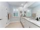 Elegant bathroom with double vanity and granite countertop at 2831 Whispering Pine Ln, North Port, FL 34287