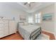 Well-lit bedroom with plenty of closet space and wood floors at 2831 Whispering Pine Ln, North Port, FL 34287