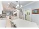 Kitchen and dining area with white cabinets and a large table at 2831 Whispering Pine Ln, North Port, FL 34287