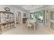 Bright dining room with white table and chairs, and access to backyard at 2831 Whispering Pine Ln, North Port, FL 34287