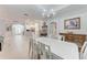 Bright dining room features a spacious table and chandelier at 2831 Whispering Pine Ln, North Port, FL 34287