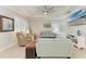 Living room with comfy sofas, a large TV, and a ceiling fan at 2831 Whispering Pine Ln, North Port, FL 34287