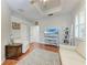 Home office with hardwood floors and built-in shelving at 2831 Whispering Pine Ln, North Port, FL 34287