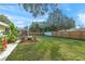 Spacious backyard with grassy lawn, fire pit, and wooden fence at 3054 Markridge Rd, Sarasota, FL 34231