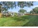 Large backyard with lush lawn and screened porch at 3054 Markridge Rd, Sarasota, FL 34231